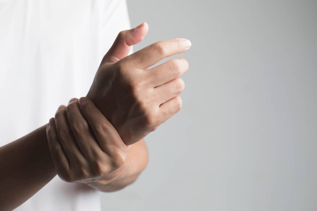 A man suffers from neuropathy issues in his hand